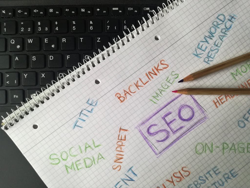 A close-up to a notebook where the words SEO and other words related to SEO are clearly visible.